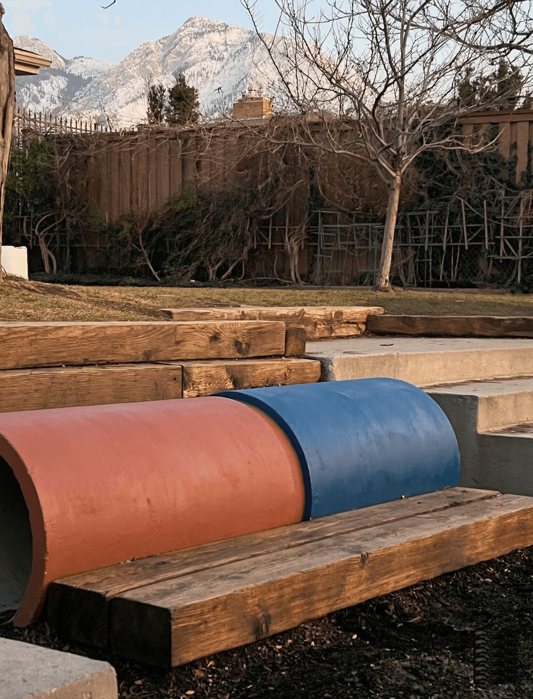 Outdoor play area with tunnel and mountain view